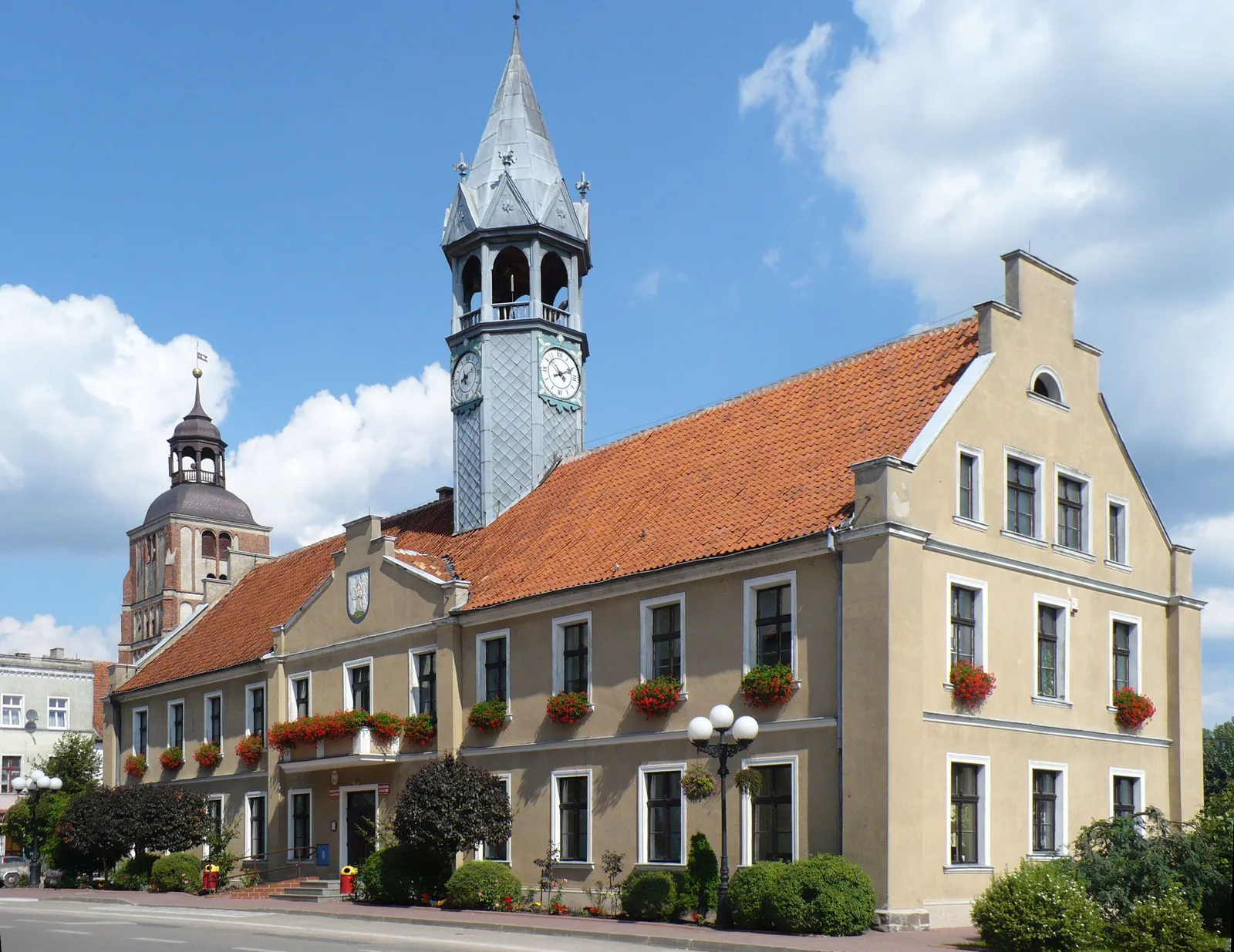Nineteenth century neo-Gothic town hall of Barczewo . In the background the tower of St. Anne of the late eighteenth and early nineteenth century.