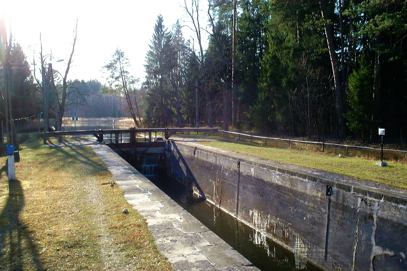Poland, Augustowski Canal - Perkuc lock. View of top gate with balance beams and lock chamber.
